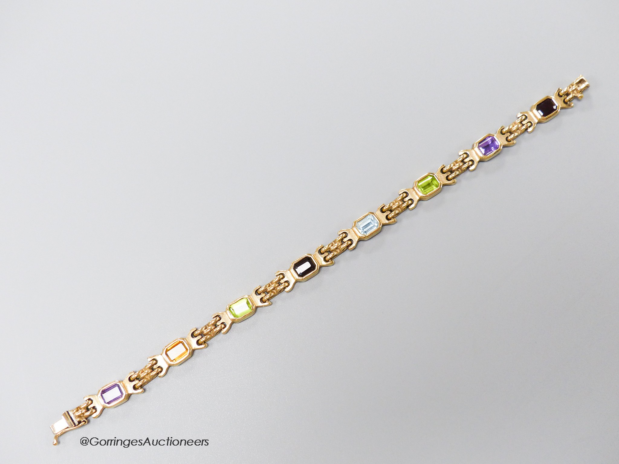 A modern 9ct gold and multi gem set bracelet, 18.4cm, gross weight 15.5 grams.